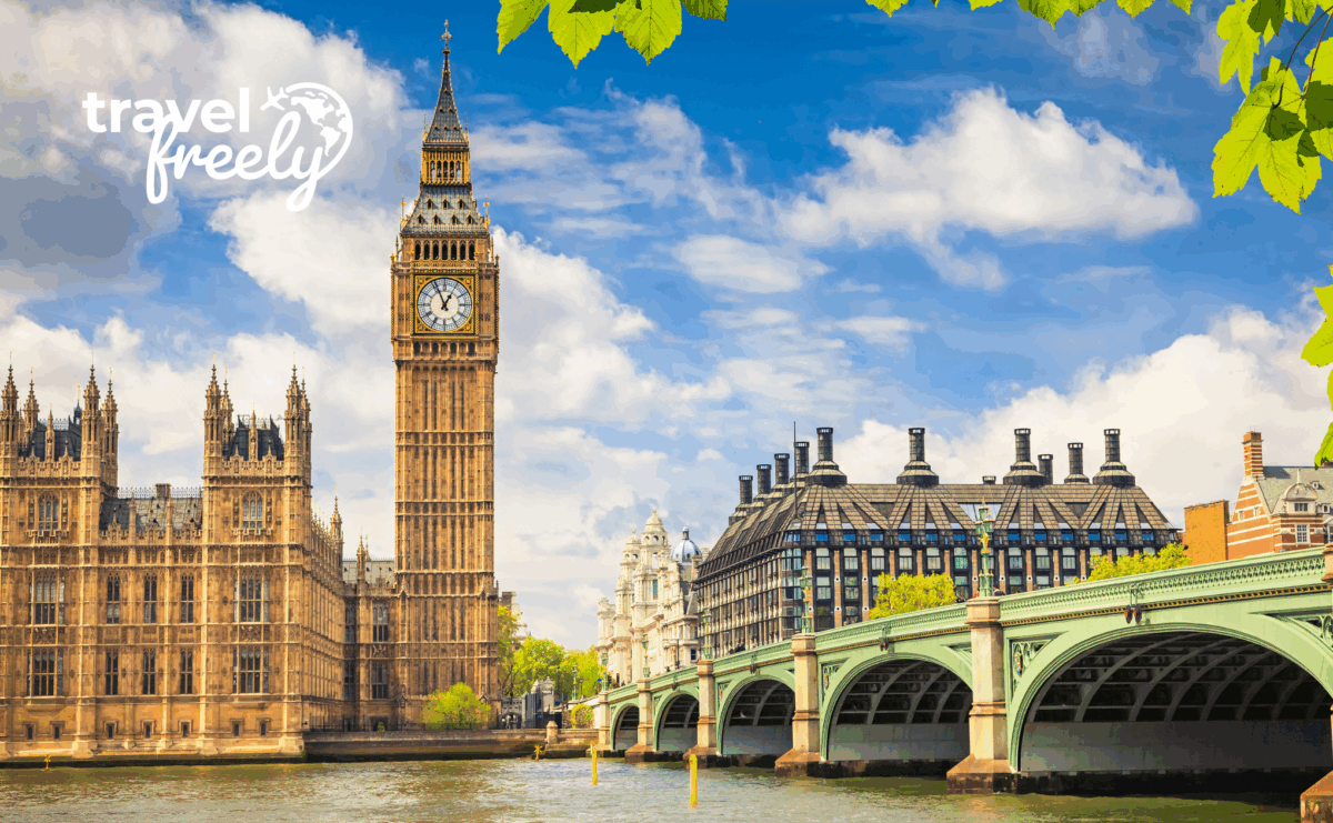 Big Ben and the Houses of Parliament in London near Westminster Bridge on a sunny day, with travel freely text in the sky and green leaves framing the top of the image.