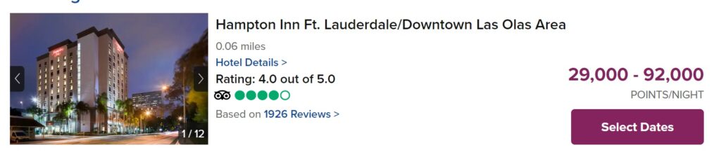 Exterior view of Hampton Inn Ft. Lauderdale/Downtown Las Olas Area hotel at dusk, with lights on and palm trees in front; hotel rating is 4.0 out of 5.0, points per night range from 29,000 to 92,000.