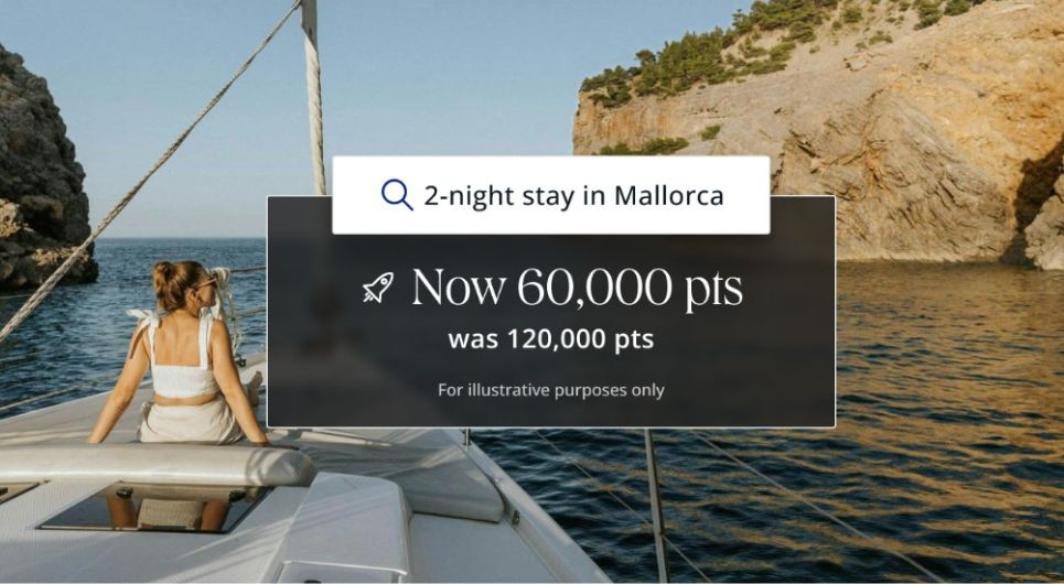 A woman sits on the deck of a sailboat looking at rocky cliffs and blue water. Text overlay reads: 2-night stay in Mallorca. Now 60,000 pts with best hotel credit cards, was 120,000 pts. For illustrative purposes only.